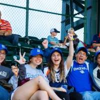 Group of five cheering in the stands of Comerica Park